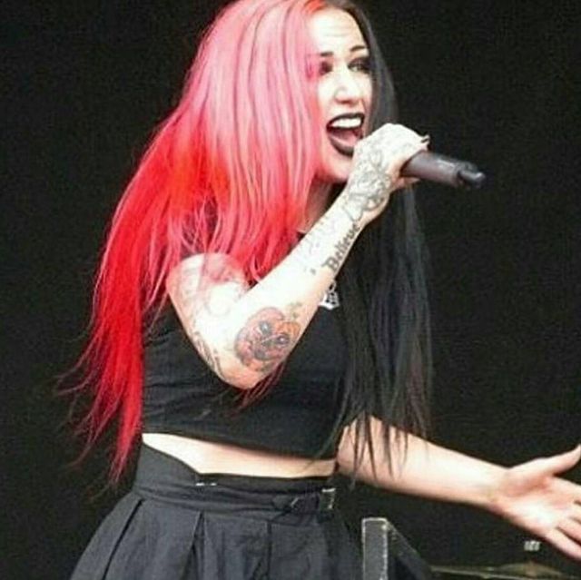 Ashley is wearing a black top and black skirt.
